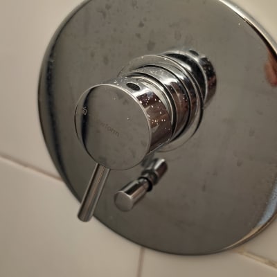 ברז אינטרפוץ ממתכת כרום מותקן על קיר אריחי קרמיקה