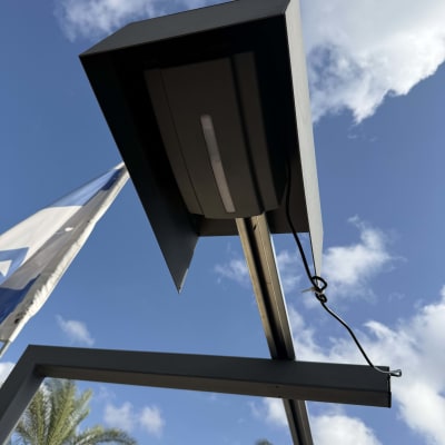 שער חשמלי עם שמיים ודקלים ברקע