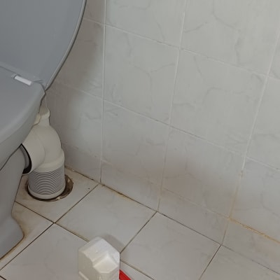 חדר שירותים עם חלקי אסלה על הרצפה