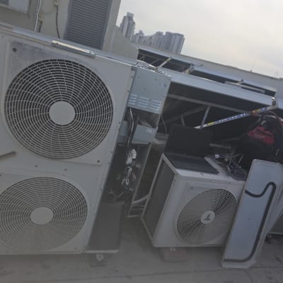 יחידות מיזוג אוויר על גג עם מחשב נייד ותיק.