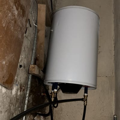 דוד שמש מותקן על קיר עם צינורות מחוברים