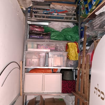 מדפים עם קופסאות פלסטיק, קרטונים ושקיות לאחסון