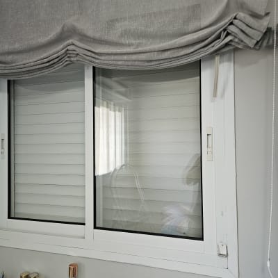 חלון עם תריסים סגורים ווילון אפור מקופל