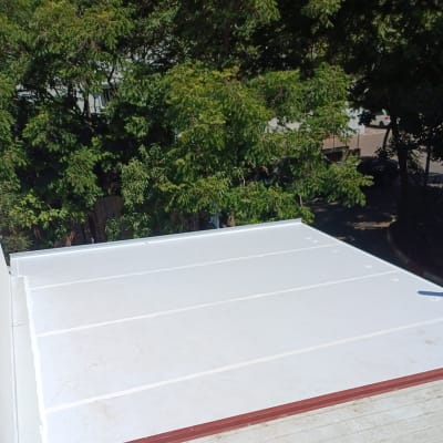 גג אלומיניום עם עצים ברקע