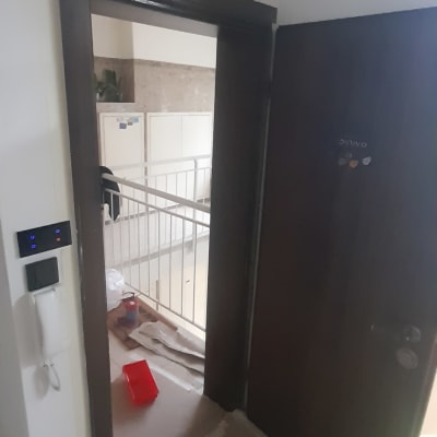 כלי צביעה אדום על הרצפה ליד דלת פתוחה