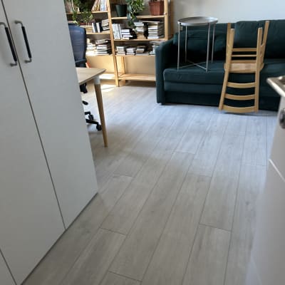 חדר עם רצפה נקייה, ספה, כיסאות ומדפי ספרים