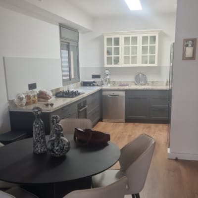 מטבח מודרני עם שולחן עגול וכיסאות לבנים