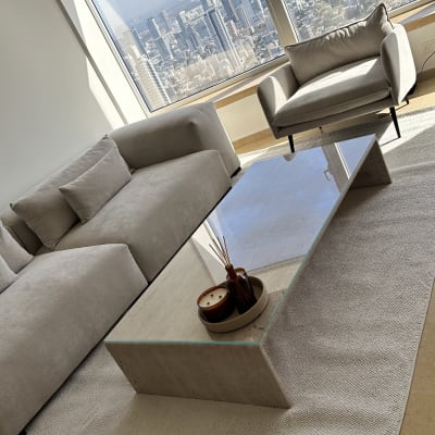 שולחן זכוכית בסלון עם נוף עירוני מחלון גדול