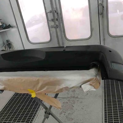 חדר צביעה עם פגוש רכב בתהליך עבודה