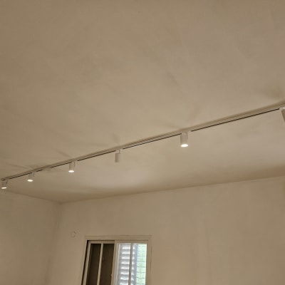תאורת מסילה עם פנסים בתקרה בחדר