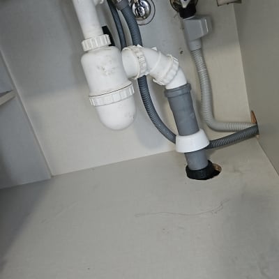 צנרת מתחת לכיור עם חיבורים ואביזרים