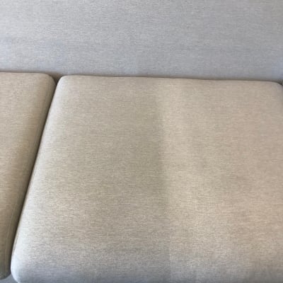 ספה אפורה עם סימני ניקוי נראים לעין