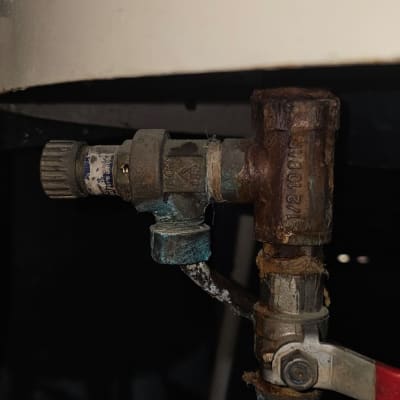 שסתום חלוד ומחובר לצינור במערכת חימום מים