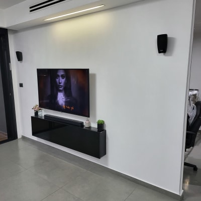 טלוויזיה תלויה על קיר עם רמקולים משני הצדדים