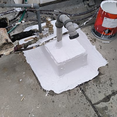 צינורות ומחברים על גג עם צבע לבן