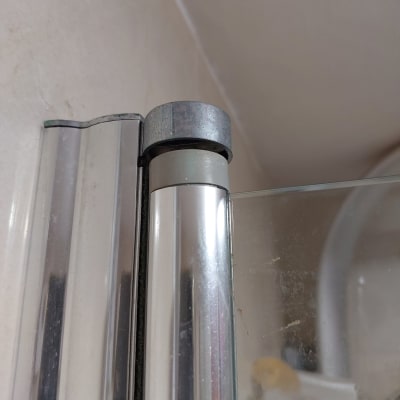 חיבור מתכת וזכוכית בדלת מקלחון