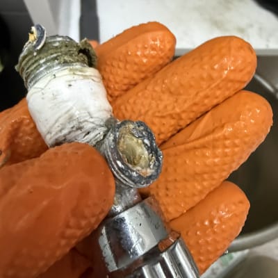 חלקי צנרת עם כפפות כתומות