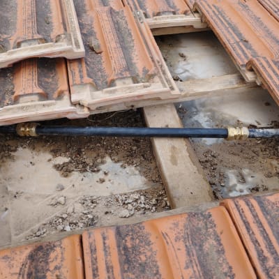 צינור שחור עם מחברים מתחת לרעפים