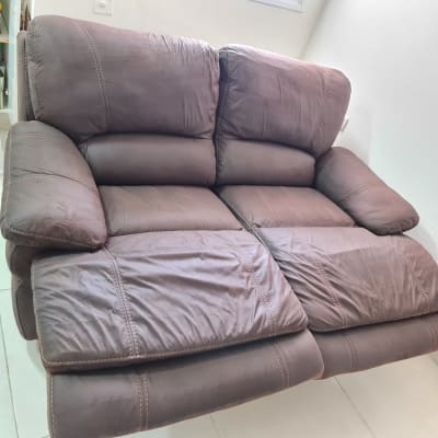 ספה חומה עם מושבים מתכווננים בחדר מואר