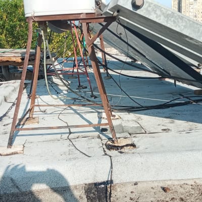 גג עם יריעות איטום, צינורות ומתקנים מתכתיים