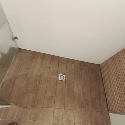 רצפת חדר אמבטיה עם אריחים חומים וניקוז