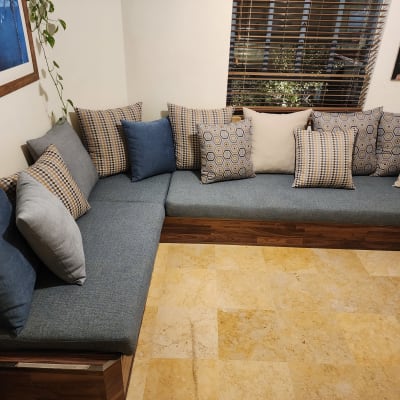 כריות צבעוניות על ספה פינתית עם ריפוד כחול