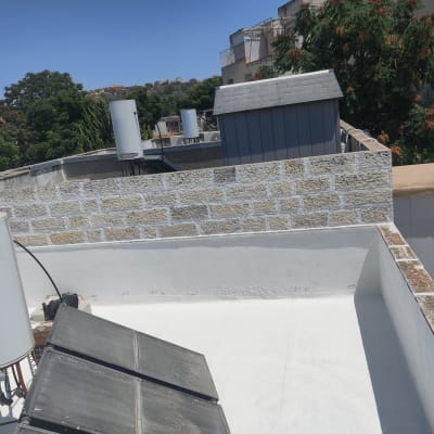 גג אטום עם קולטי שמש ודודי מים