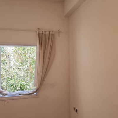 קיר צבוע עם חלון ווילון פתוח