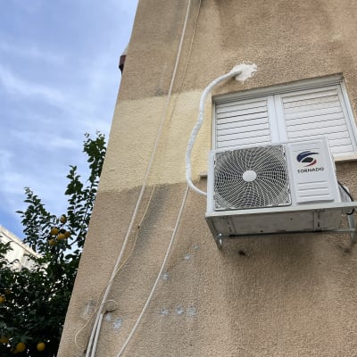 צינור אטום בחומר לבן על קיר חיצוני