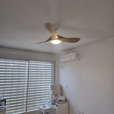 מאוורר תקרה ומזגן בחדר עם חלון גדול