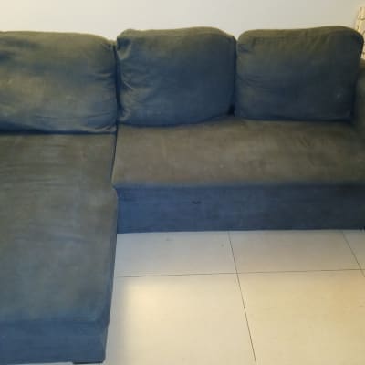 ספה כהה על רצפת אריחים בהירה