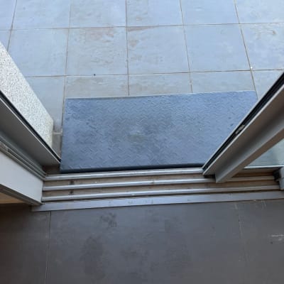 רצפה נקייה עם שטיח כניסה ליד דלת פתוחה