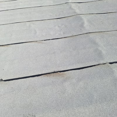 יריעות איטום מונחות על גג עם מבער גז