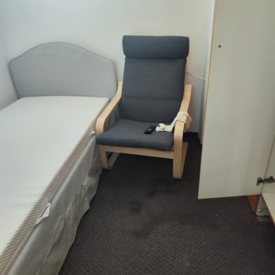 חדר עם כורסה, מיטה וארון פתוח