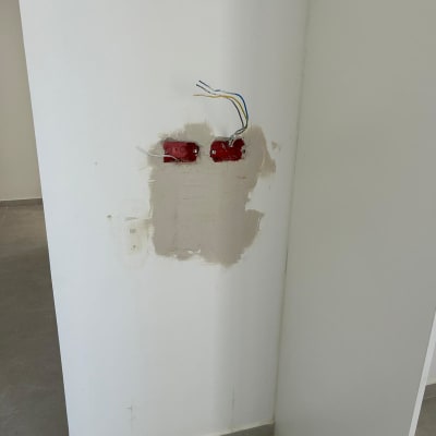 שני שקעים חשמליים עם חוטים חשופים בקיר