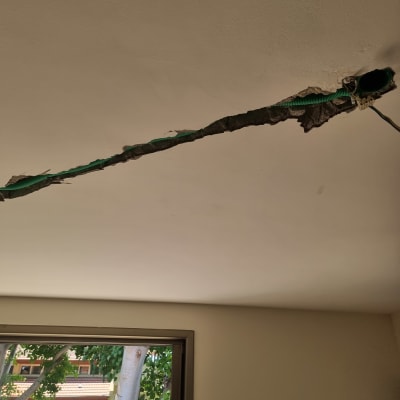 תקרה עם חוטי חשמל חשופים ותעלה פתוחה