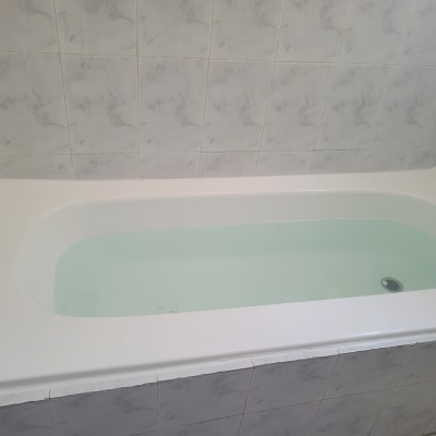 אמבטיה עם חיפוי קרמיקה לבן על הקירות