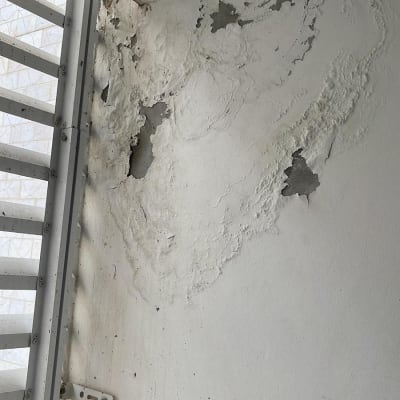 קיר עם נזקי רטיבות והתקלפות צבע