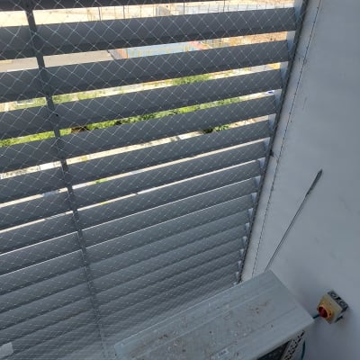 רשת מתכת על חלון למניעת כניסת יונים