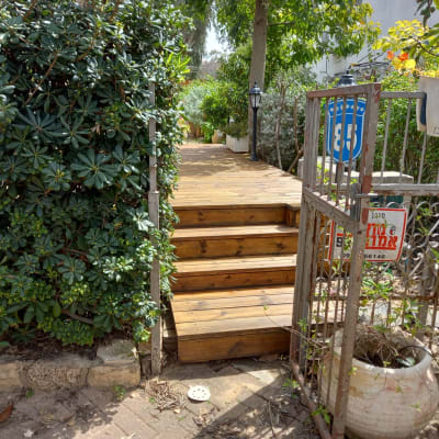 wooden steps leading to a garden path