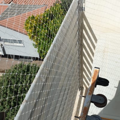 רשת הגנה מותקנת על מרפסת למניעת כניסת יונים