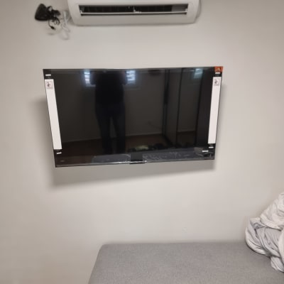 מזגן וטלוויזיה מותקנים על קיר בחדר