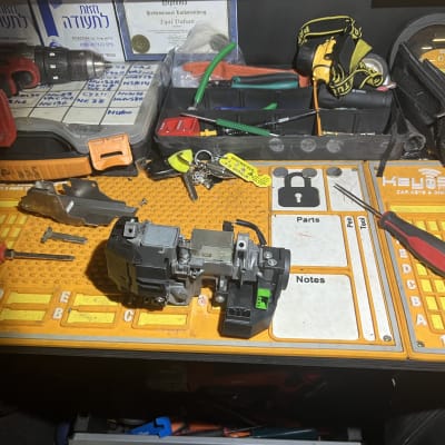 כלי עבודה ומנעול רכב על שולחן עבודה של מנעולן