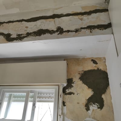 קיר עם טיח מתקלף ותיקוני טיח טריים