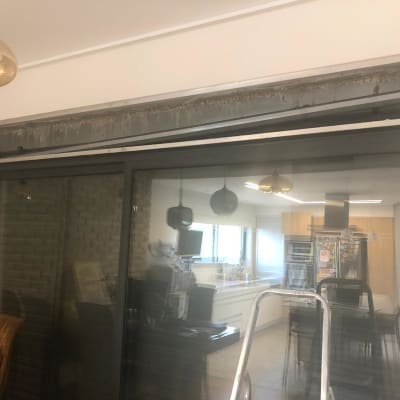 תריסים חשמליים פתוחים מעל דלת זכוכית גדולה