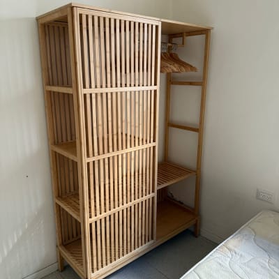 ארון עץ ריק ליד מיטה בחדר ריק