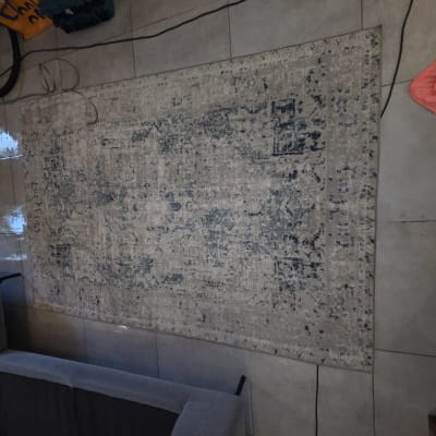 שטיח על רצפה עם מכונת ניקוי וסמרטוט