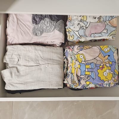 בגדים מקופלים במגירה מסודרת עם הדפסים צבעוניים