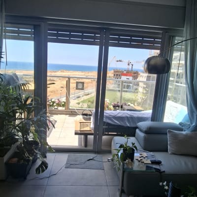 סלון עם חלונות גדולים ונוף לים