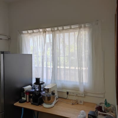 מיקסר ומכונת קפה על שולחן עץ ליד חלון